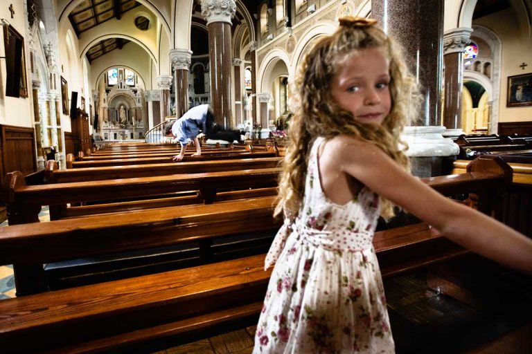 Despite the silence and holiness of the church, children play jumping on the benches. Even during the church service parents struggle to repress their exuberance.