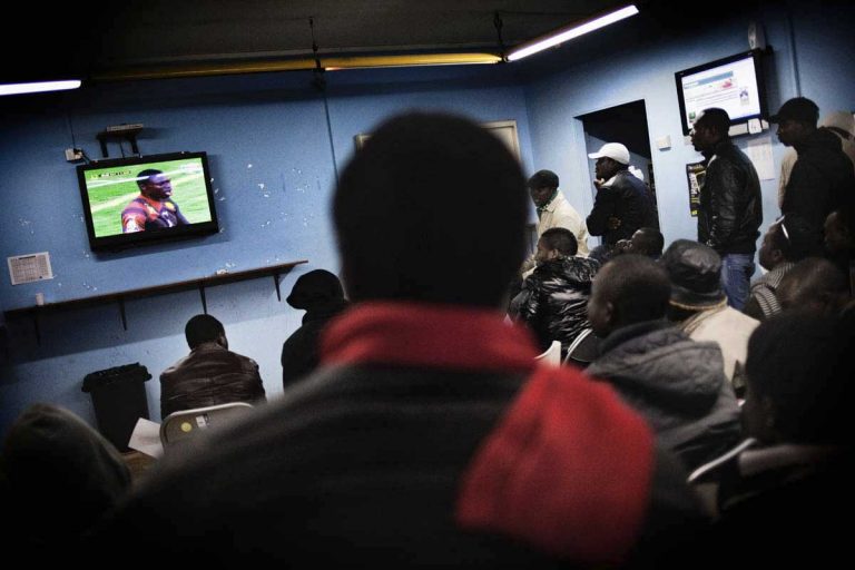 People watching the African Football Cup in a betting centre. Half of the foreigners living in Castel Volturno are from Ghana.